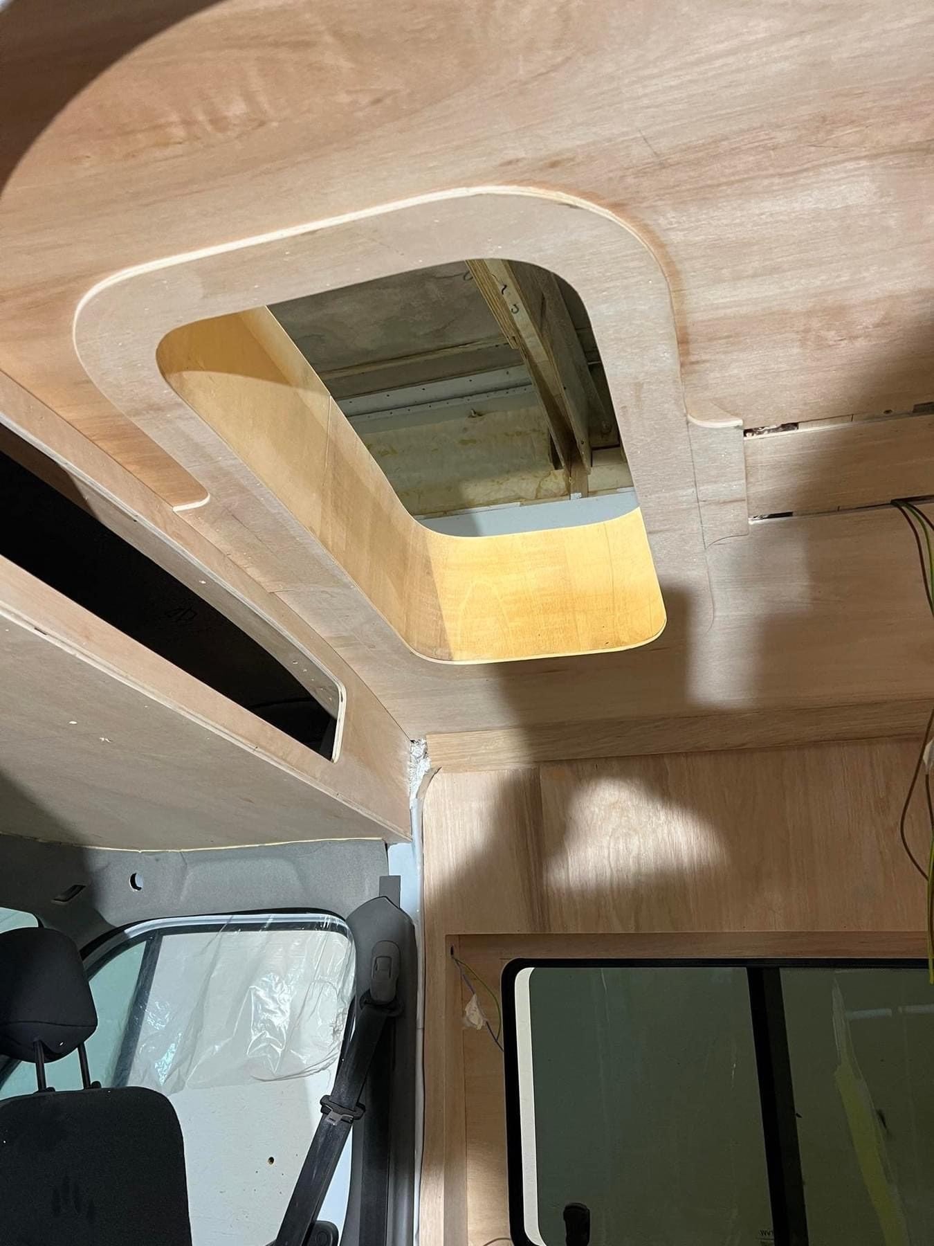 A curved window surround shaped to the van's own lines