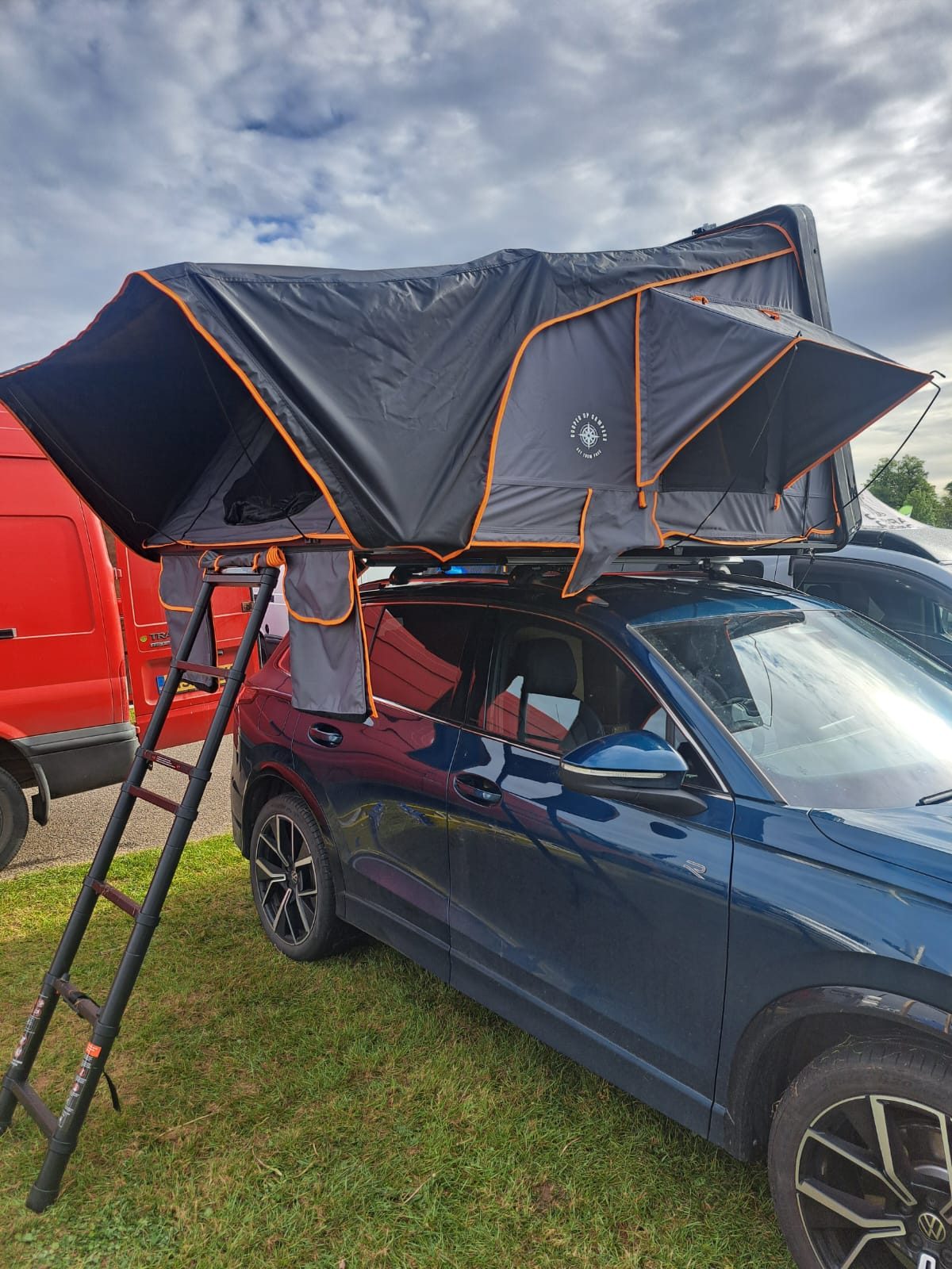 Hard shell roof top tent pitched on a car